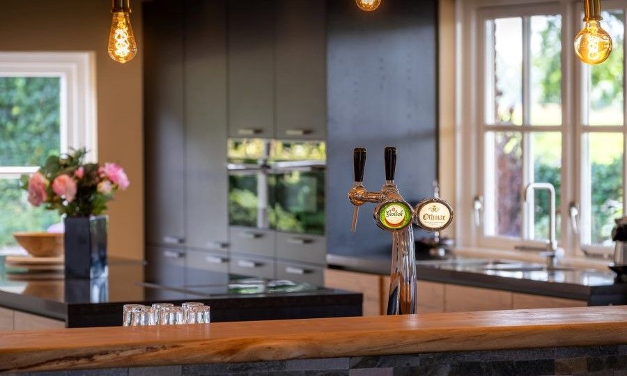 Moderne Kueche mit Bar im Ferienhaus Landgoed Nieuwhuis in Ootmarsum, Twente, ideal zum Kochen und Essen.