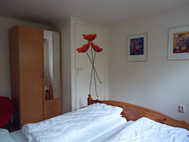 Gemtliches Doppelzimmer im Ferienhaus Mapadodo, Nutter, Twente mit floraler Wanddekoration.