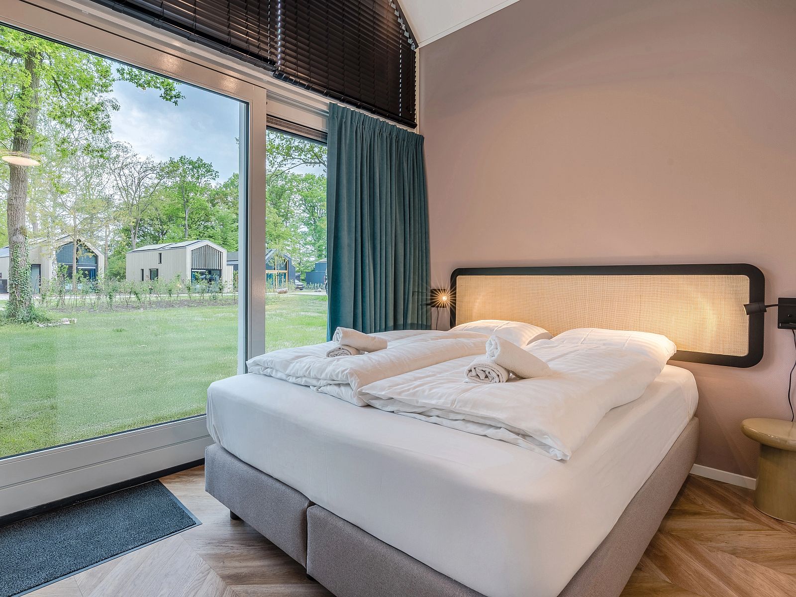 Bedroom with large window in 4-bed dog house 4LD, Beuningen, Twente, overlooking greenery.