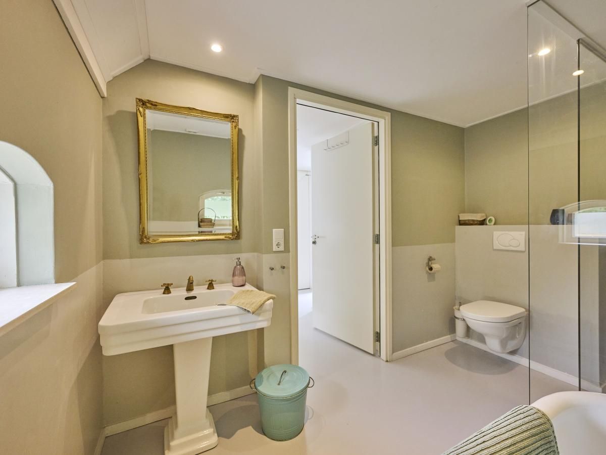 Modernes Wohnzimmer in der Design Lodge Twente, Haaksbergen, Overijssel, mit grossen Fenstern und stilvollen Moebeln.