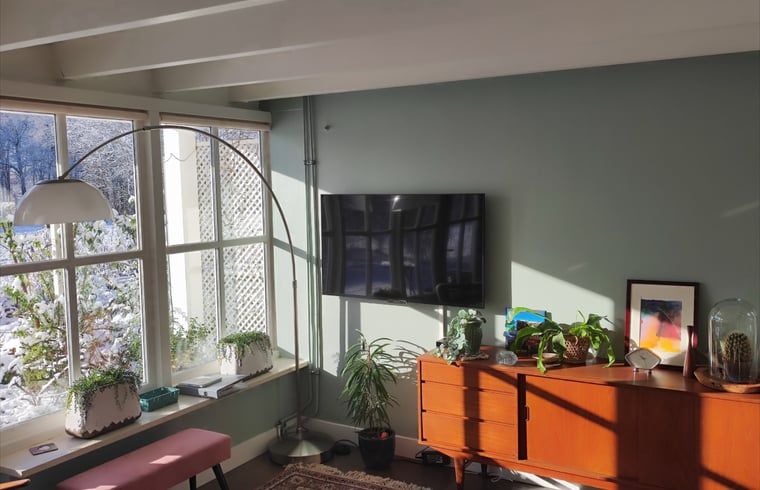 Stilvolle Sitzecke mit Fernseher im Cottage in Oldenzaal, perfekt zum Entspannen.