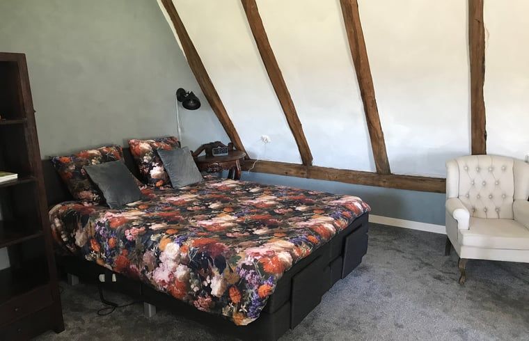 Gezellige slaapkamer in Vakantiehuisje in Markelo, Twente, Overijssel met houten balken en comfortabele inrichting.