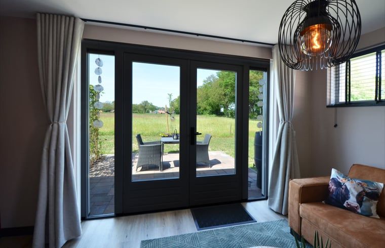 Vakantiehuis in Denekamp, uitzicht op het terras vanuit de woonkamer in Twente, Overijssel.