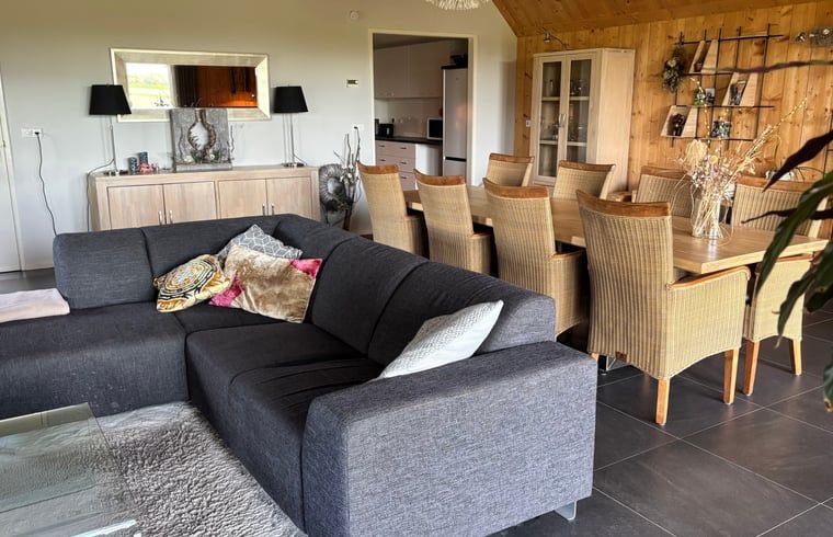 Dining area in vacation home in Denekamp, Twente, with comfortable chairs. Enjoy meals in this vacation home in Overijssel.
