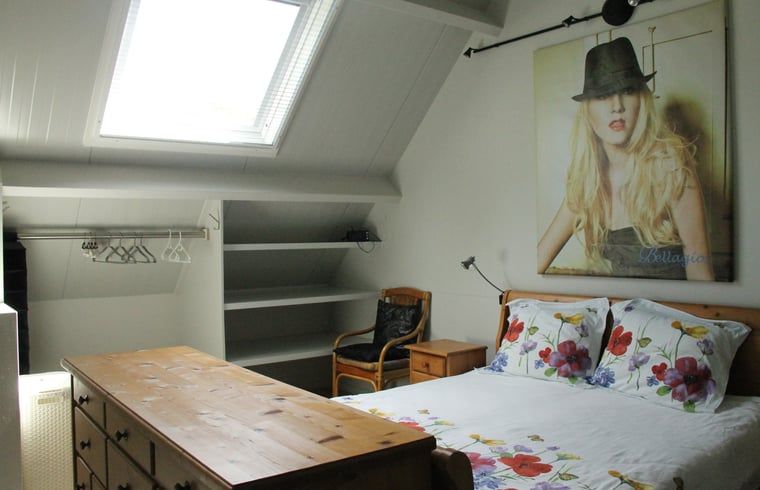 Bedroom under the roof in vacation home in Denekamp, Twente, with skylight. Unique vacation home in Overijssel.