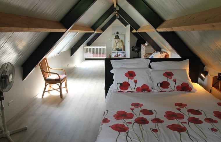 Attic with wooden beams in vacation home in Denekamp, Twente. Authentic vacation home in Overijssel.