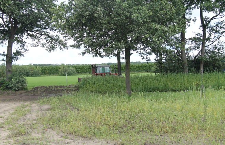 Rural surroundings of vacation home in Denekamp, Twente, with tractor in the background. Quiet vacation home in Overijssel.