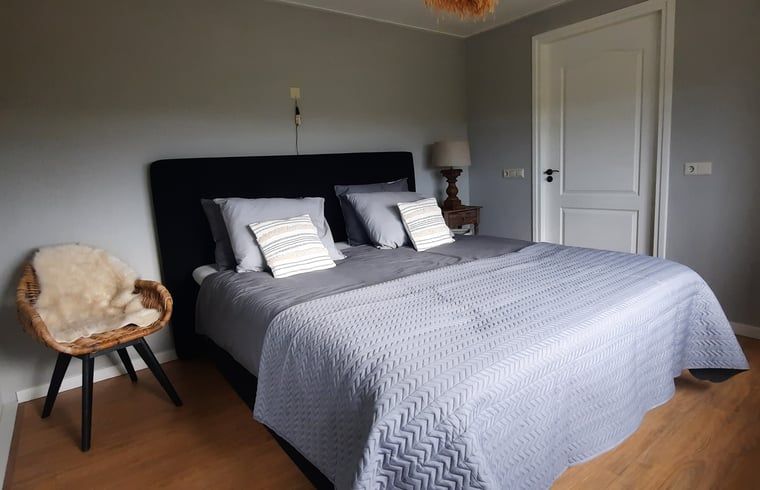 Cozy bedroom with wooden details in vacation home Manderveen, Twente, Overijssel.