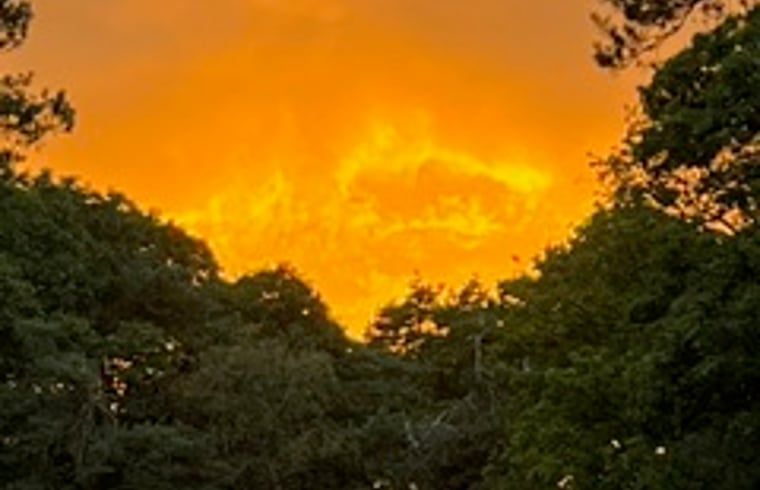 Breathtaking sunset at Huisje in Buurse, vacation home in Twente, with fiery sky.