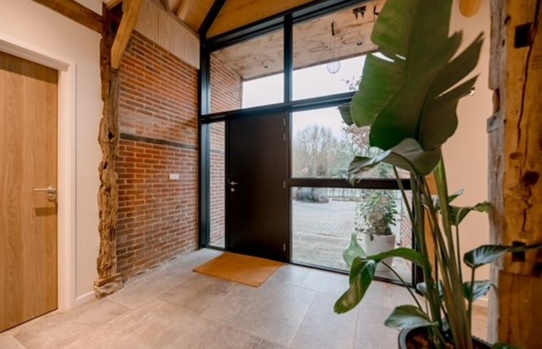Entrance of Cottage in Agelo in Twente, Overijssel, overlooking the nature and modern interior of the cottage.