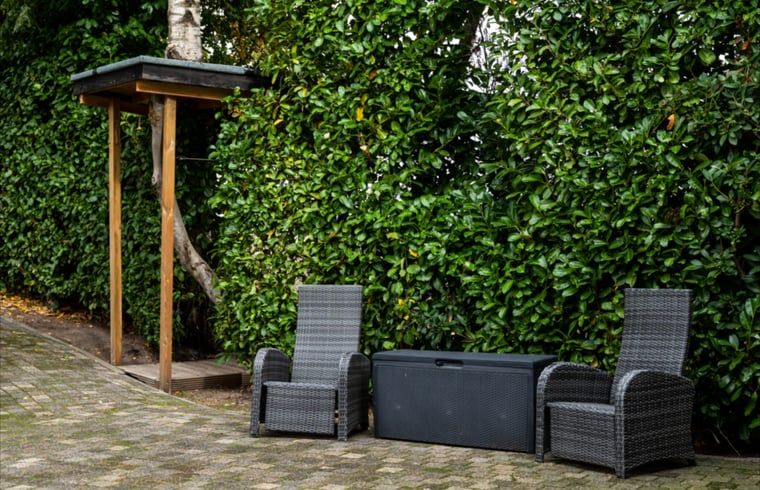 Gezellige veranda met uitzicht op natuur in vakantiehuis in Vroomshoop, Twente.