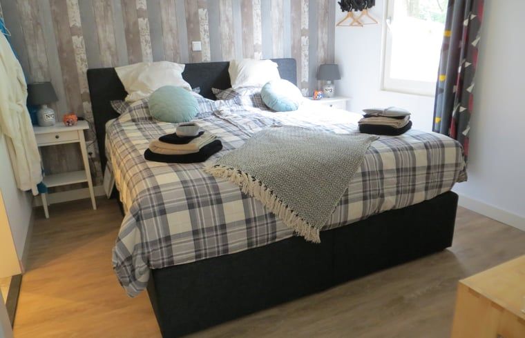 Komfortables Schlafzimmer im Ferienhaus in Boekelo, Enschede, mit einem grossen Bett fuer eine gute Nachtruhe.