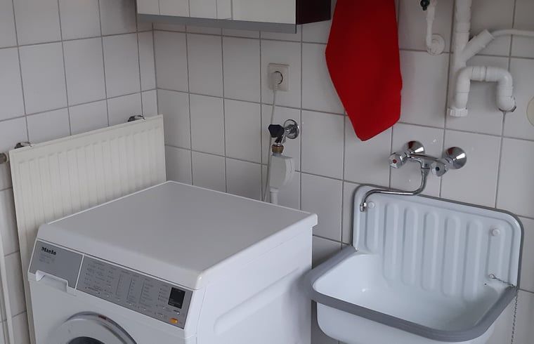 Practical laundry room in Holiday home in Lattrop Breklenkamp with washing machine and sink in Twente, Overijssel.
