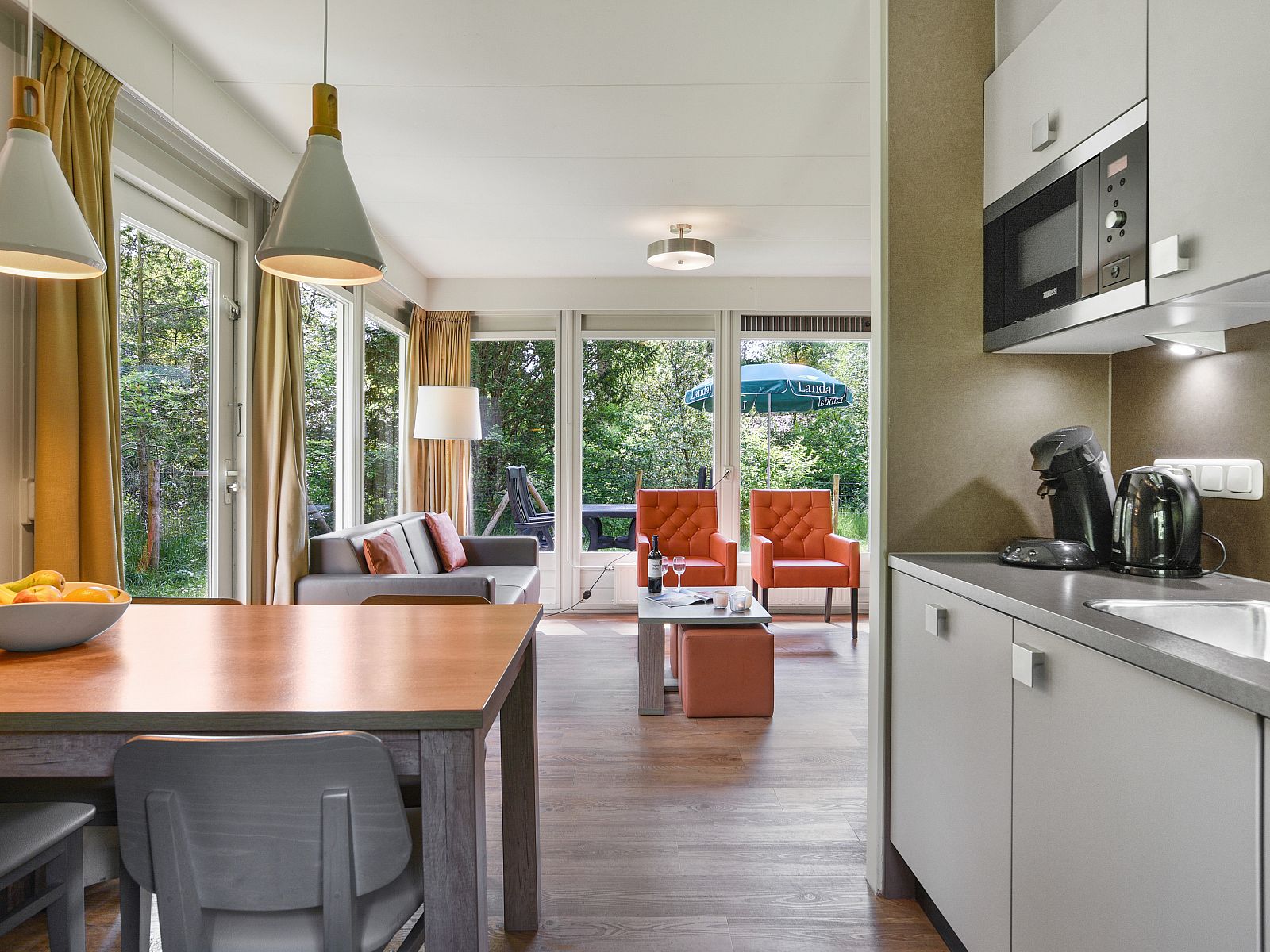 Dining area with a view in Twenhaarsveld dog bungalow, Holten, Salland, for cozy meals.