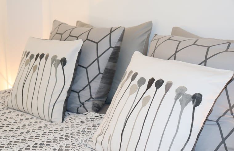 Stylish pillows in the bedroom of Huisje in Zwolle, Salland, Overijssel.