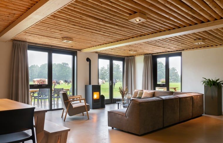 Spacious sitting area in Cottage in Heeten with large windows, ideal for a stay in Salland, Overijssel.