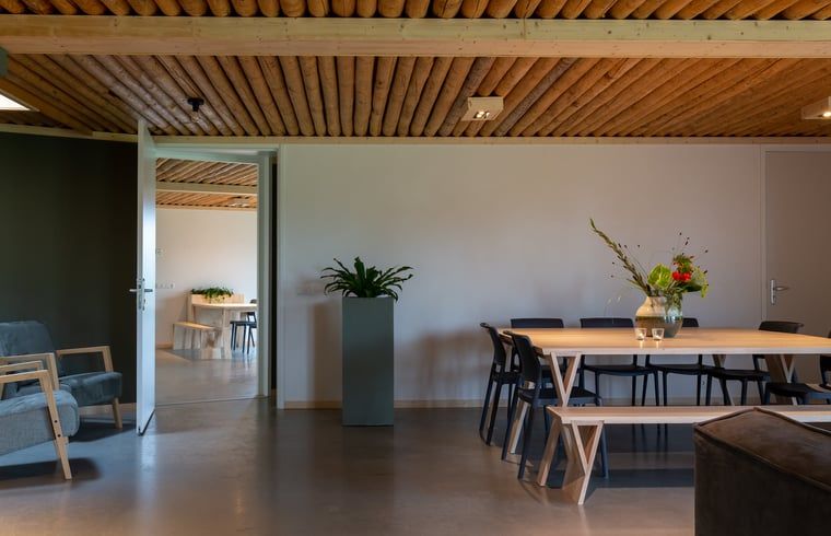 Dining room with wooden table in Holiday home in Heeten in picturesque Salland, Overijssel.