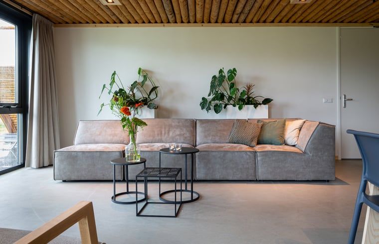 Cozy living room with wood stove in Holiday cottage in Heeten, located in serene Salland, Overijssel.