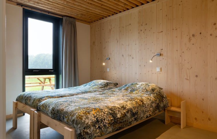 Cozy bedroom under wooden ceiling in Holiday cottage in Heeten, perfect for a stay in Salland, Overijssel.
