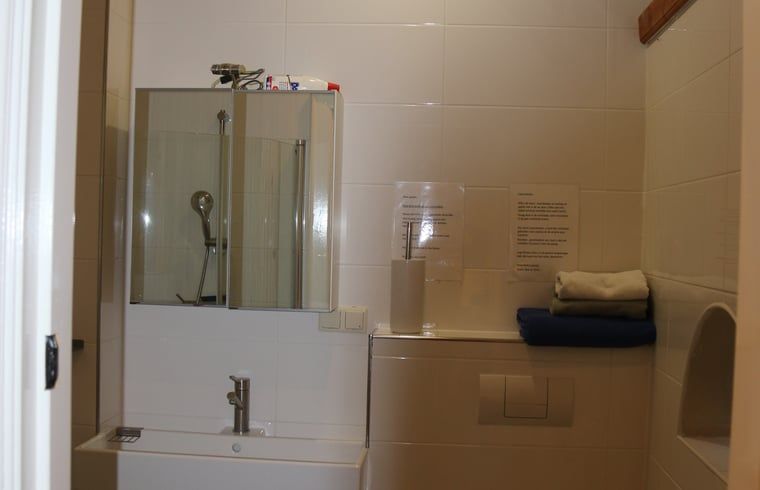 Practical bathroom in cottage in Heeten, Salland, with clean white tiles.
