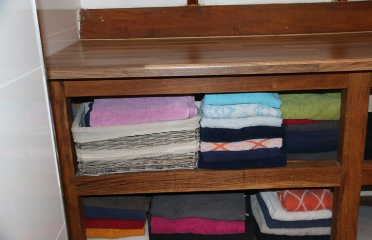 Towel rack in cottage in Heeten, Salland, with colorful towels.