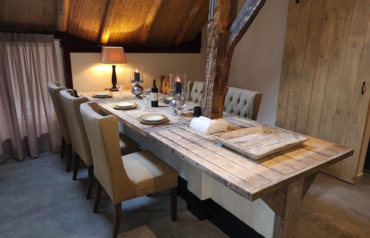 Cozy dining room in Holiday home in Nieuwleusen, Salland, with wooden table in Overijssel.