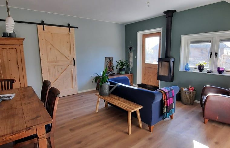 Cozy living room of Holiday Home in Wesepe, Salland with wood stove and wooden interior.