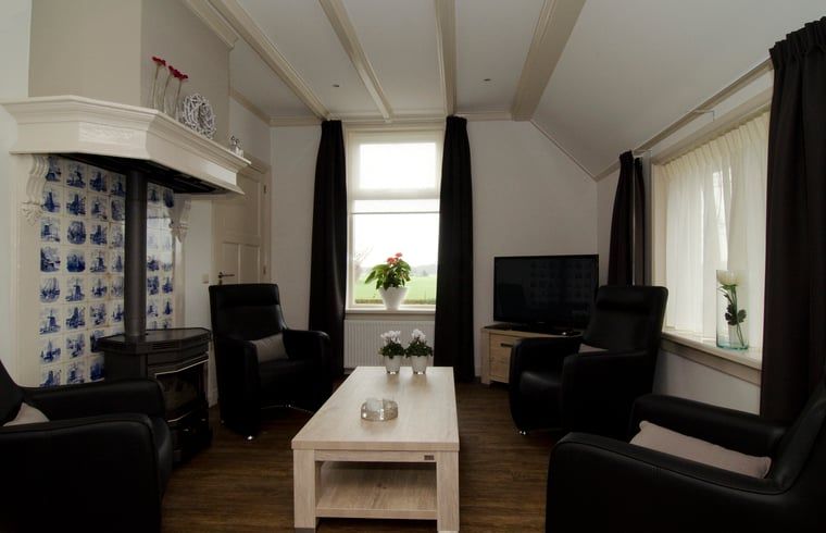 Cozy living room in Cottage in Dalfsen, cottage in the Vecht region, Overijssel with comfortable sitting area and views of nature.