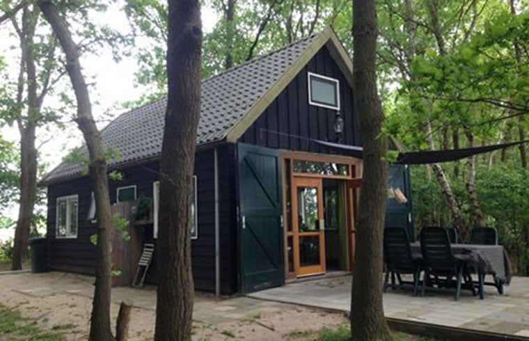 Terrace at Cottage in Dalfsen, Vecht region, Overijssel, ideal for outdoor dining in a wooded area.