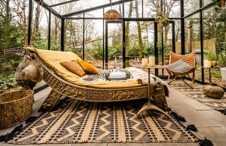 Gemuetlicher Wintergarten im Ferienhaus in Rheezerveen, Vechtstreek, Overijssel mit bequemen Liegestuehlen und Blick auf die Natur.