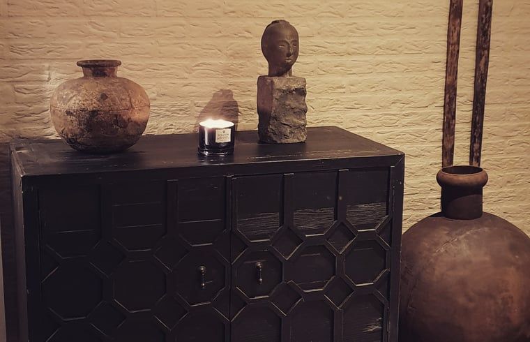 Stilvoller Schrank mit Dekorationen im Ferienhaus in Rheezerveen, Vechtstreek, Overijssel fuer ein warmes Ambiente.