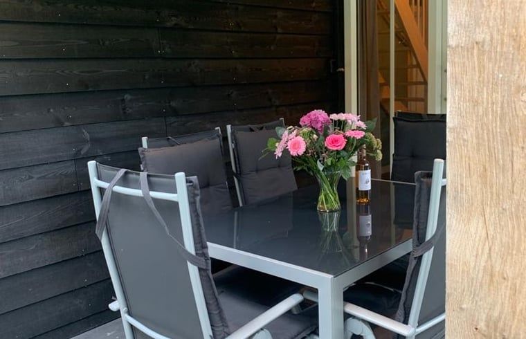 Cozy dining area on the porch of Holiday Home in Marienberg, Vechtstreek, Overijssel.