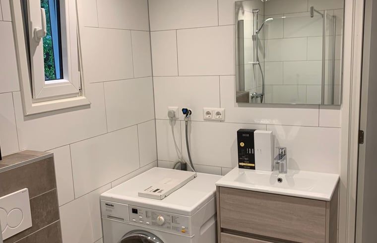 Practical laundry room in cottage in Marienberg, Vechtstreek, Overijssel, with washing machine.