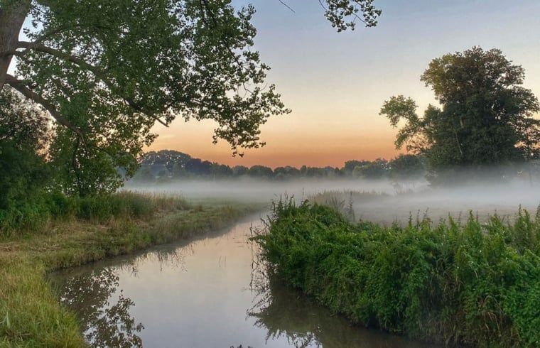 Atmospheric sunrise near cottage in Marienberg, Vecht region, Overijssel.