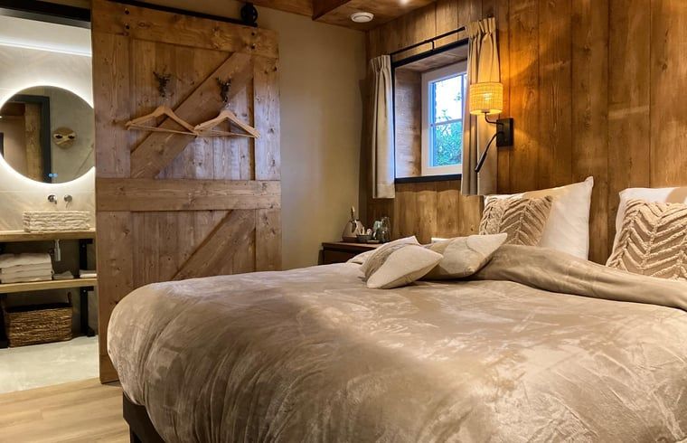 Attractive bedroom in Holiday cottage in Giethmen, Vechtstreek, Overijssel with wooden interior and comfortable beds.