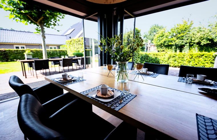 Dining table in Holiday home in Hoonhorst overlooking garden, Vecht region, Overijssel.