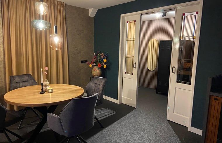 Stylish dining room with flower vase in Holiday cottage in Kloosterhaar, Vechtstreek, Overijssel.