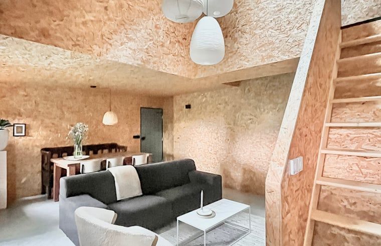 Cozy interior of Holiday Home in Kloosterhaar, Overijssel, with modern furnishings and wooden details for a cozy atmosphere.