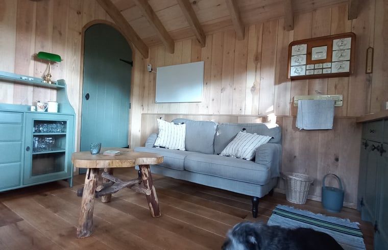 Stijlvolle woonkamer van vakantiehuis in Brucht, Vechtstreek, Overijssel met houten interieur.