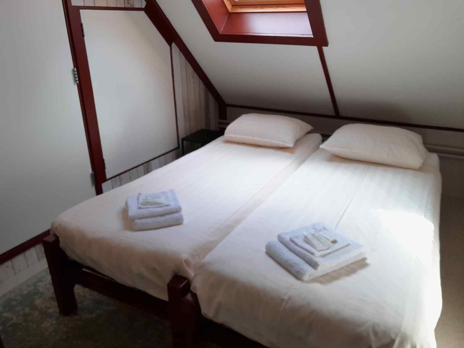 Bedroom in OV602 vacation home in Giethoorn with comfortable beds and skylight.