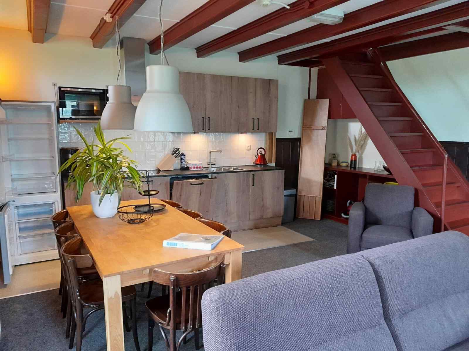 Cozy indoor area of vacation home OV602 in Giethoorn with modern kitchen and dining table.