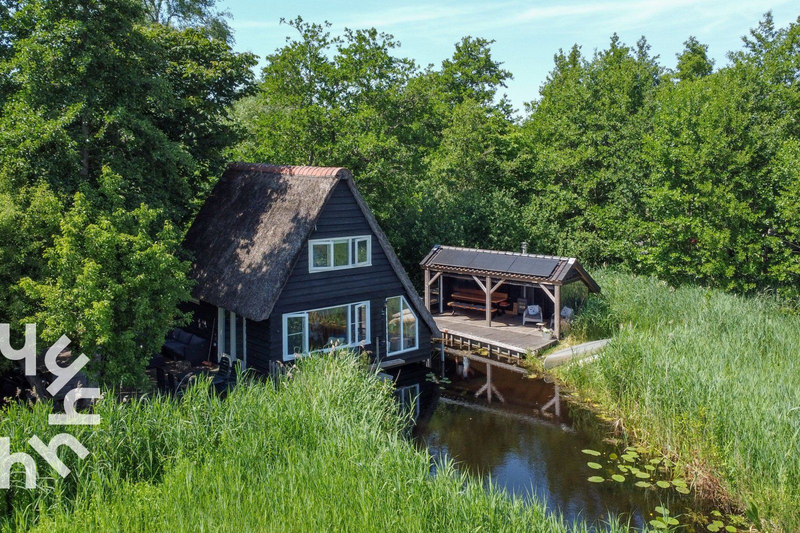 Ferienhaus OV465 in Giethoorn, Overijssel, mit Reetdach und umgeben von Gruenanlagen.