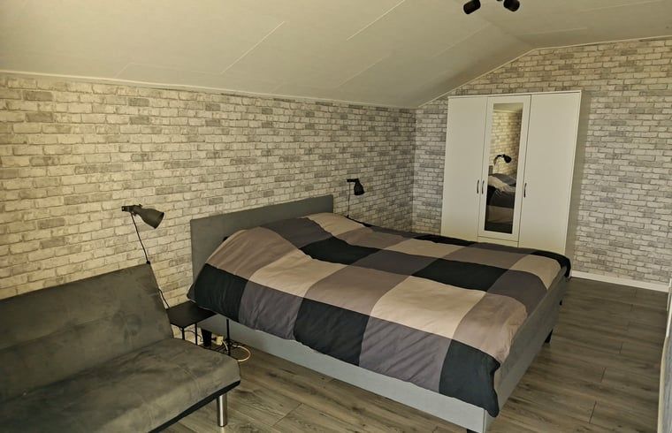Cozy living room in a vacation home in Zwartsluis, Northwest Overijssel, with a view of nature from the spacious interior.