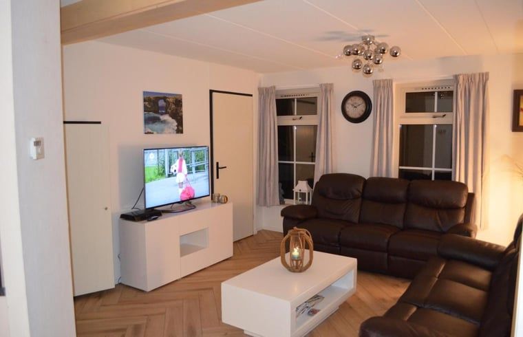 Geraeumiges Wohnzimmer mit Ledersofas im Ferienhaus in IJhorst, Overijssel.