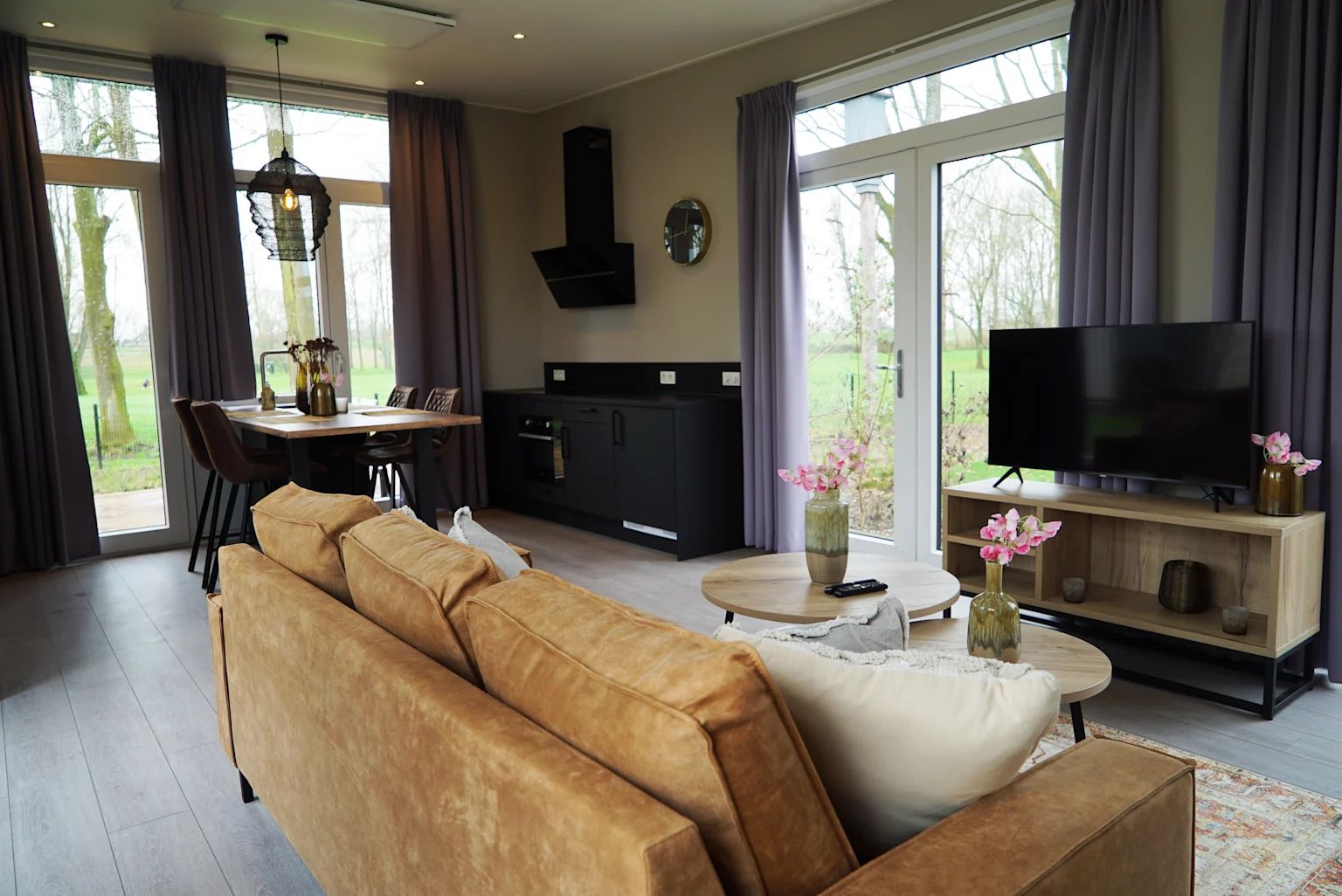 Stylish living room in the detached house in IJhorst, Overijssel, with modern interior and views of green nature.