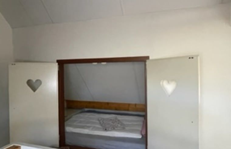 Cozy bedroom in Holiday Home in IJhorst with unique built-in bed and heart-shaped details.