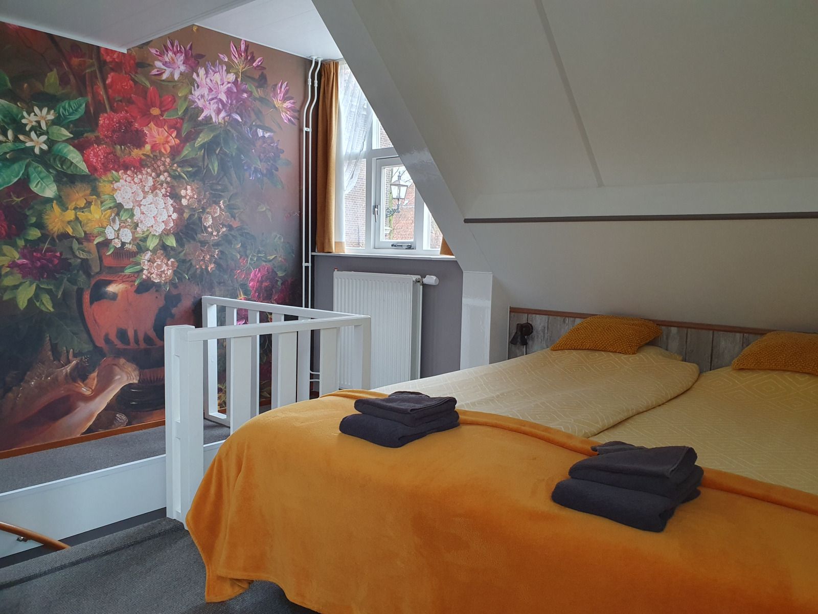 Attractive bedroom in OV684 vacation home, Blokzijl, with colorful flower wallpaper, Northwest Overijssel.