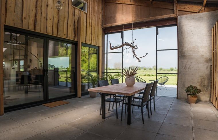 Cozy dining area in Holiday Home in Zalk overlooking the countryside of Northwest Overijssel.