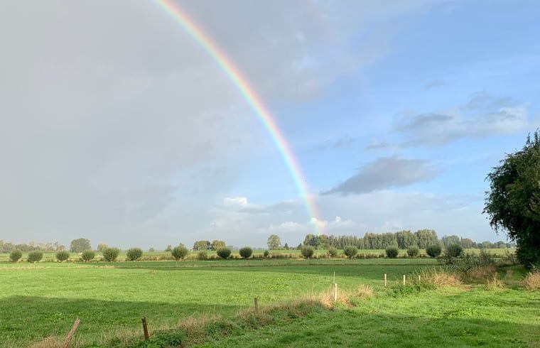Breathtaking views of a rainbow over the fields at Holiday Home in Zalk, Northwest Overijssel.