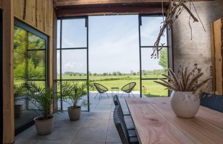 Veranda overlooking the landscape of Holiday Home in Zalk, Northwest Overijssel, Overijssel.